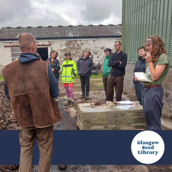 A group of people with light and medium light skin tone stand in a circle at a worksite. Logo: Glasgow Seed Library